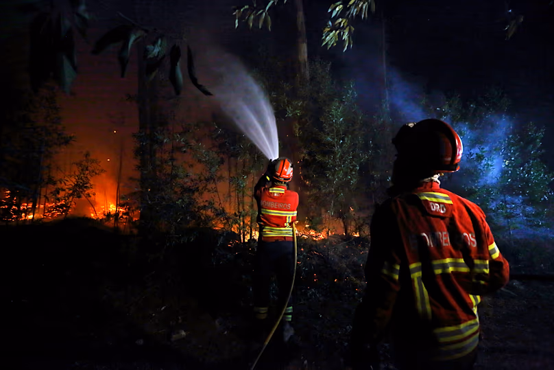 A firefighter works to extinguish a fire on the outskirts of Sever do Vouga, 18 September, 2024