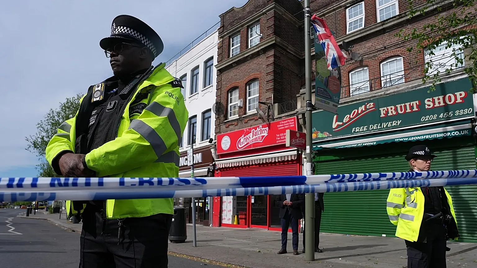 Police officers stand in the area where two people were stabbed in Golders Green, 29 April, 2026