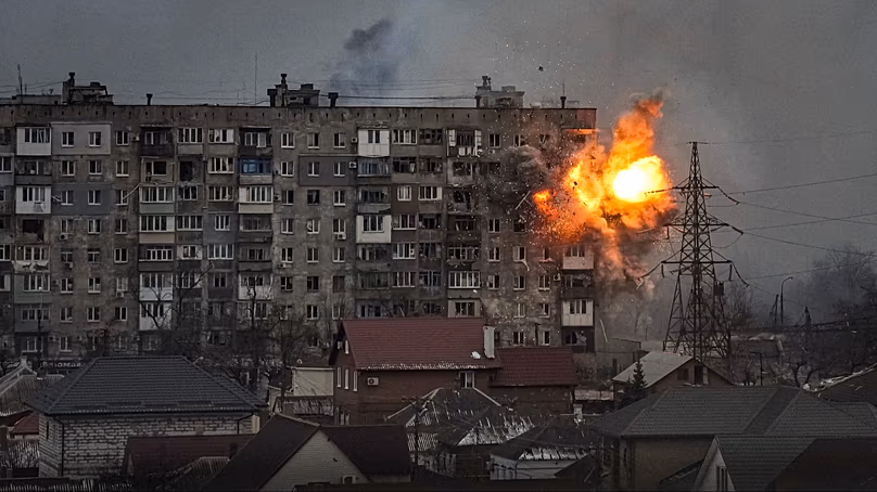 An explosion erupts from an apartment building at 110 Mytropolytska St., after a Russian army tank fired on it in Mariupol, Ukraine, Friday, March 11, 2022