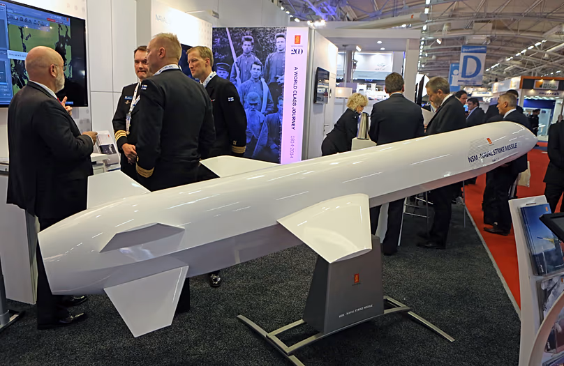 Visitors are gathered next to a display of an NSM Naval Strike Missile made by Norwegian company Kongsberg in Le Bourget, 29 October, 2014
