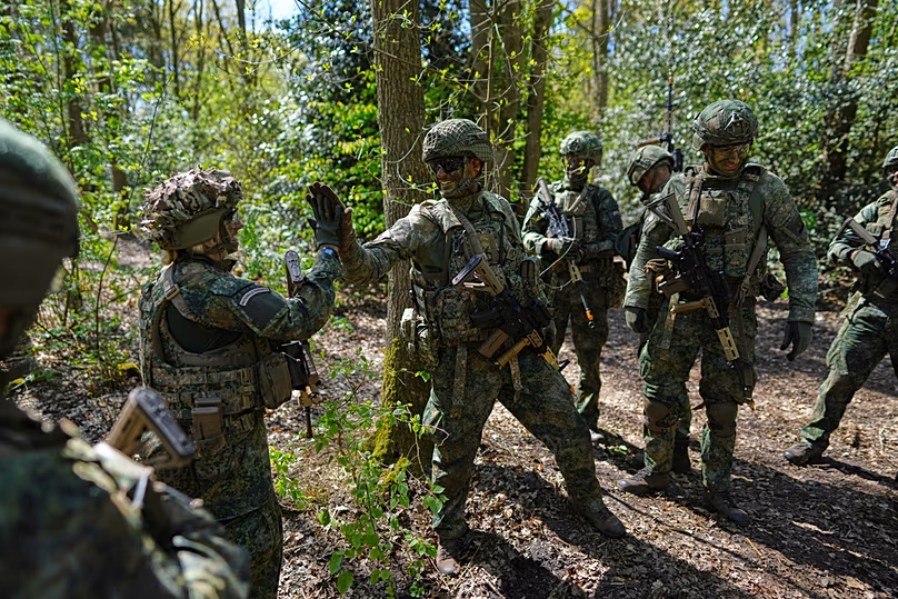 Members of the 10th Infantry Battalion Guard Security Corps National Reserve high-five after unearthing an enemy foxhole during a weekend exercise to hone their military skill