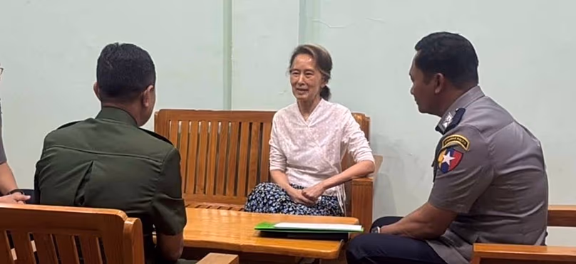 The country's former leader Aung San Suu Kyi talks with officials in an undisclosed location in Myanmar, undated
