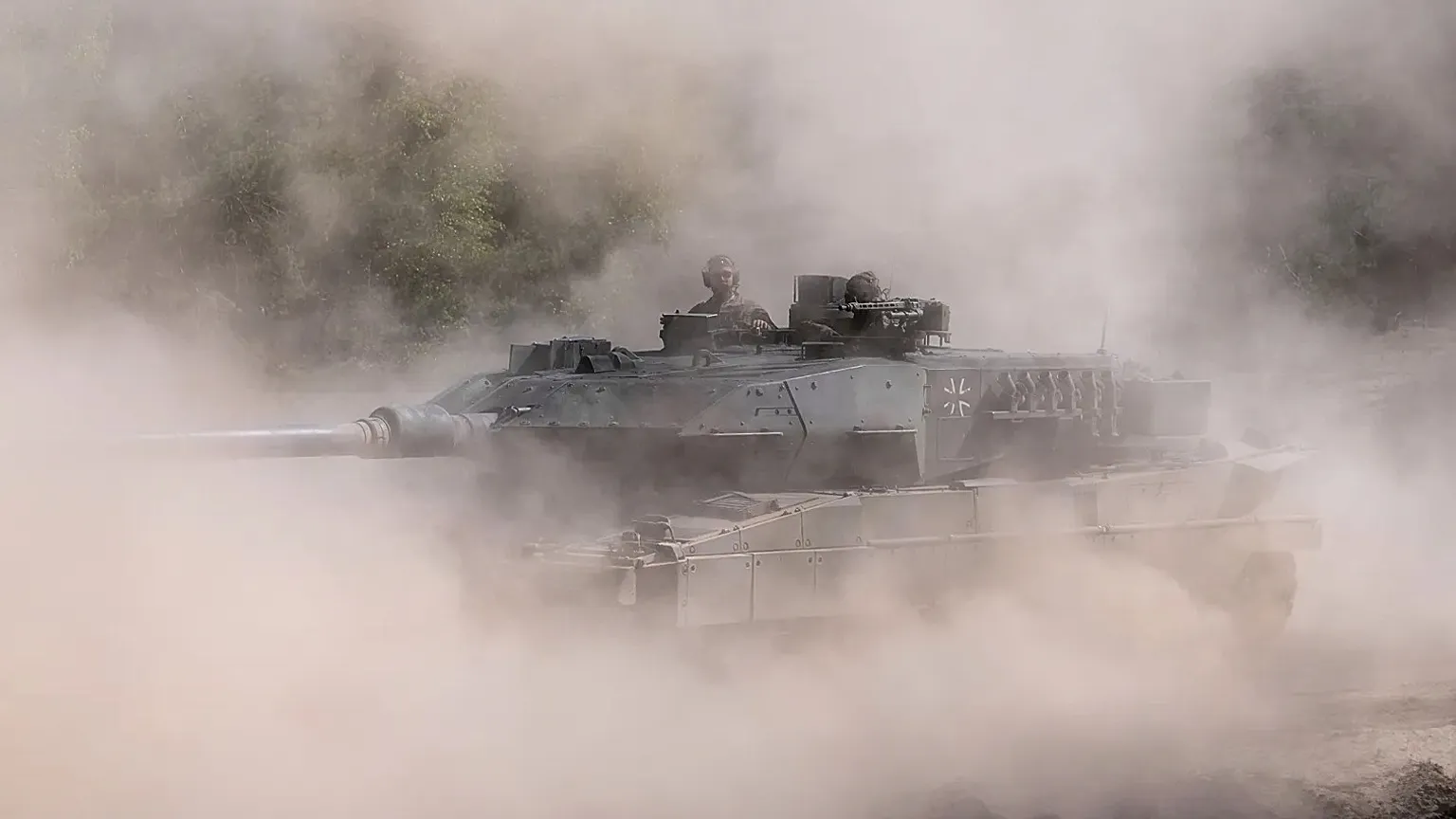 Soldiers drive a tank the dust at the Bundeswehr base in Munster, Germany, Thursday, April, 30, 2026. 