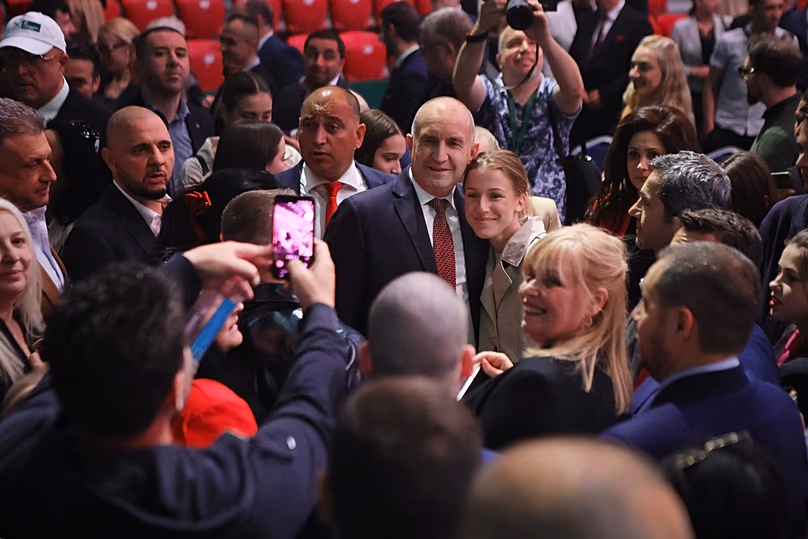 Former Bulgarian President Rumen Radev poses with a supporter at the closing rally of his campaign, in Sofia, Thursday, April 16, 2026