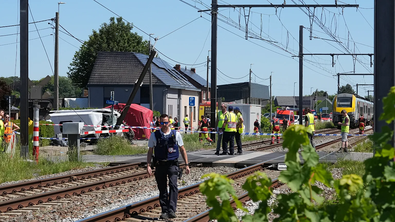 Rescue workers on the scene of a crash between a train and vehicle in Buggenhout, 26 May, 2026