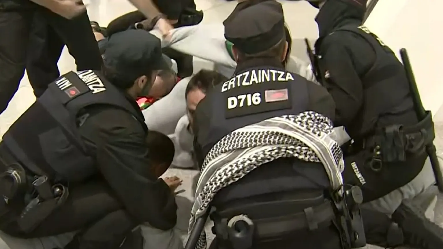 Ertzaintza officers charge at activists at Bilbao airport, Spain, on 23 April 2026.