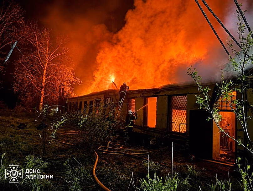 In this photo provided by the Ukrainian Emergency Service, firefighters put out a fire a building following a Russian drone attack in Odesa, Ukraine, Saturday, May 2, 2026