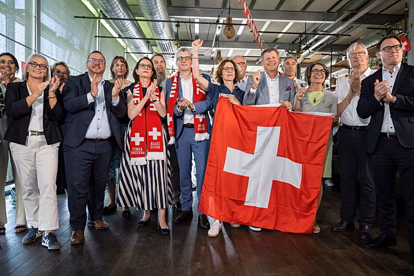 Members of the Federal Parliament and other representatives of civic organizations, celebrate during a get-together of a cross-party alliance against SVP's popular initiative.