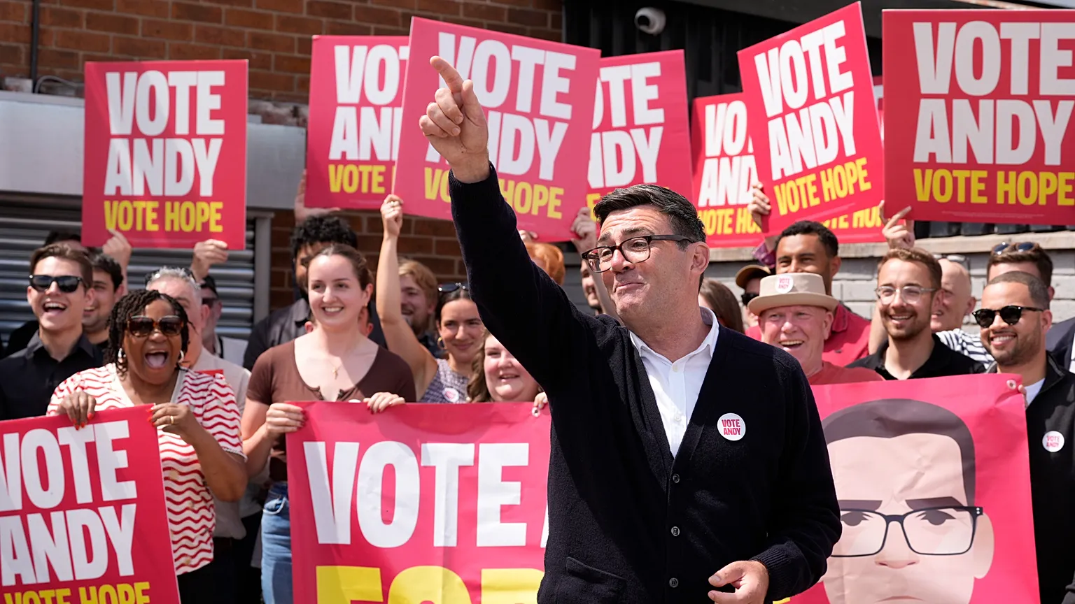 Labour candidate Andy Burnham gestures, surrounded by supporters at the Stubshaw Cross Community and Sports Club as voting is underway in the Makerfield by-election.