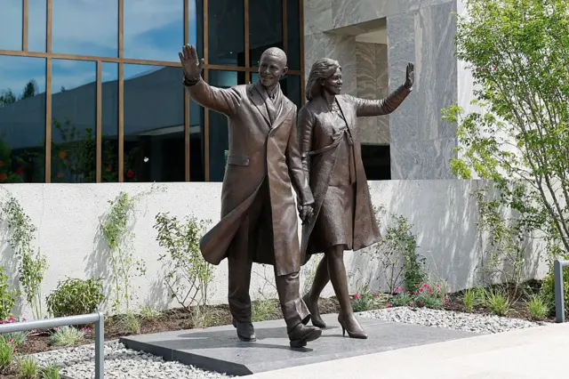 Una estatua de bronce situada en el exterior del edificio representa a Barack y Michelle Obama saludando con la mano.