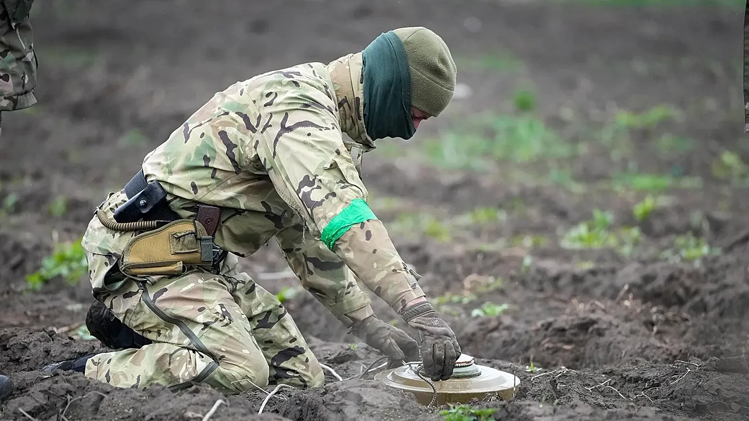 An interior ministry sapper defuses a mine on a minefield after recent battles in Irpin close to Kyiv, Ukraine, on April 19, 2022.