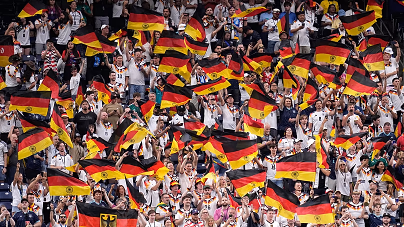 Germany fans wave flags on the stands before the start of the World Cup Group E match between Germany and Curacao in Houston, Sunday, June 14, 2026.
