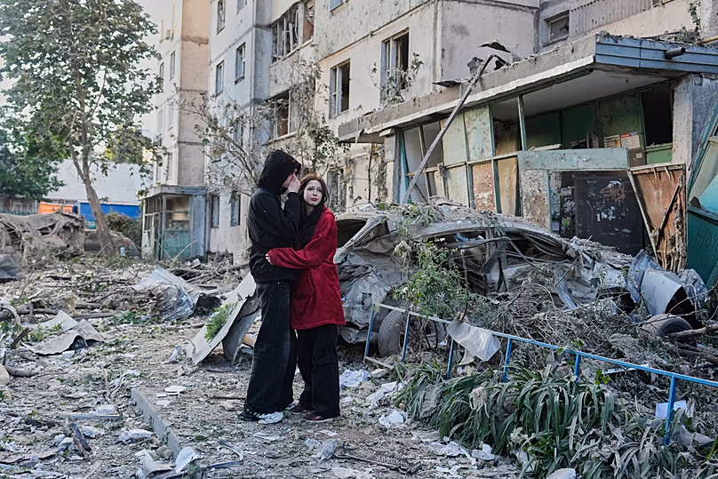 People react as they look at the site of a Russian missile strike that hit a residential building in Kyiv, 2 June, 2026