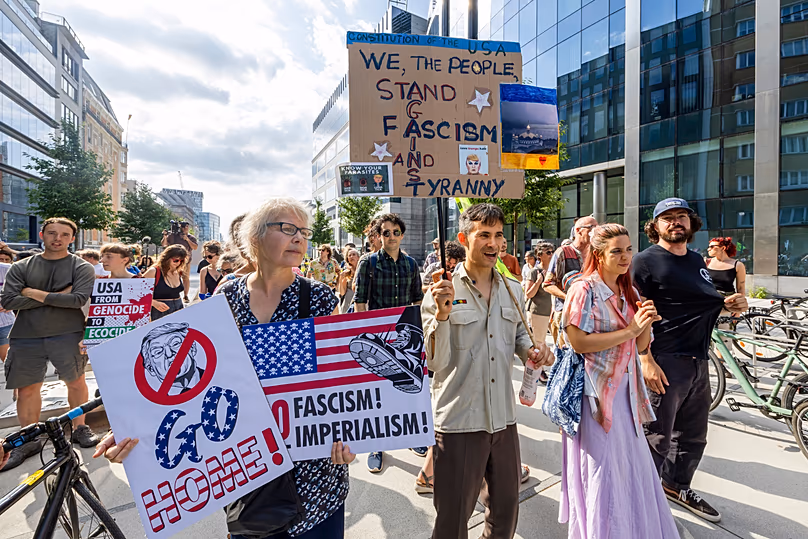 Protestors demonstrate against the America 250 event taking place in the Cinquantenaire Park in Brussels, Sunday, June 28, 2026. (AP Photo/Geert Vanden Wijngaert)