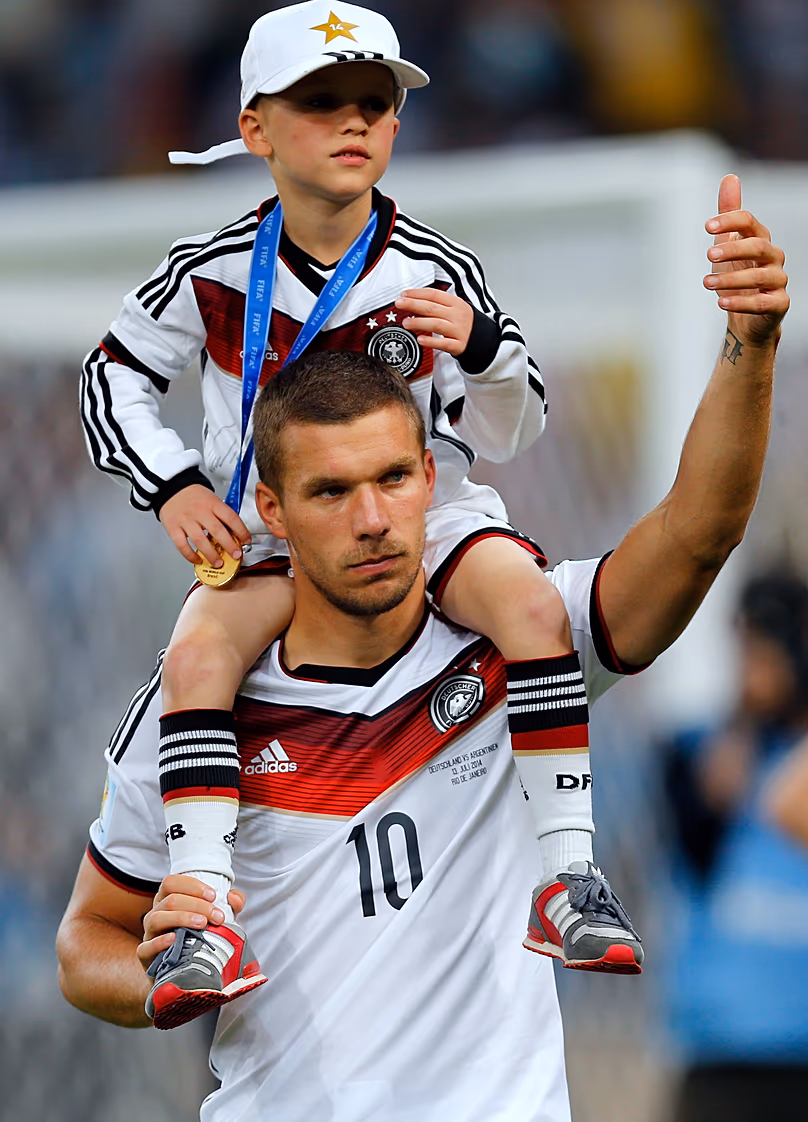 Lukas Podolski with his son Louis Gabriel after the World Cup final between Germany and Argentina in Brazil in July 2014.