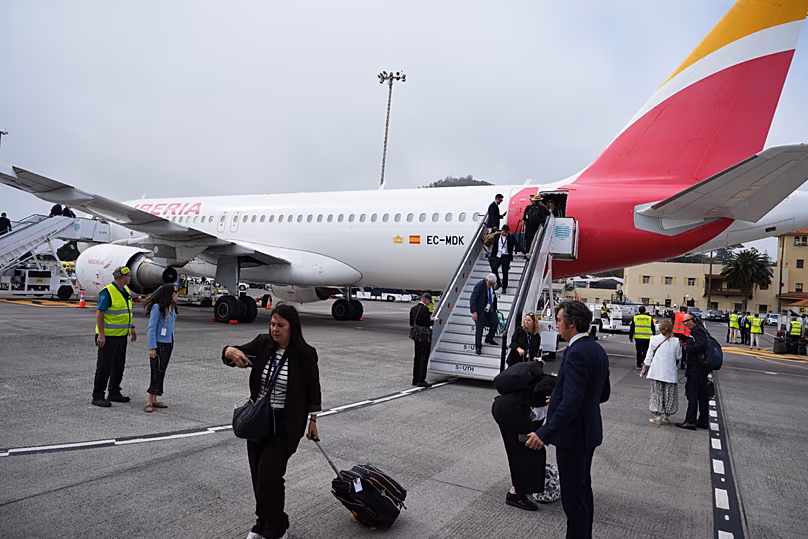 Journalists leave the papal flight after take-off was delayed at Los Rodeos International Airport, 12 June, 2026