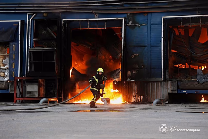 A rescue worker puts out a fire of a storage depot damaged after a Russian strike on the Dnipropetrovsk region, 4 June, 2026 