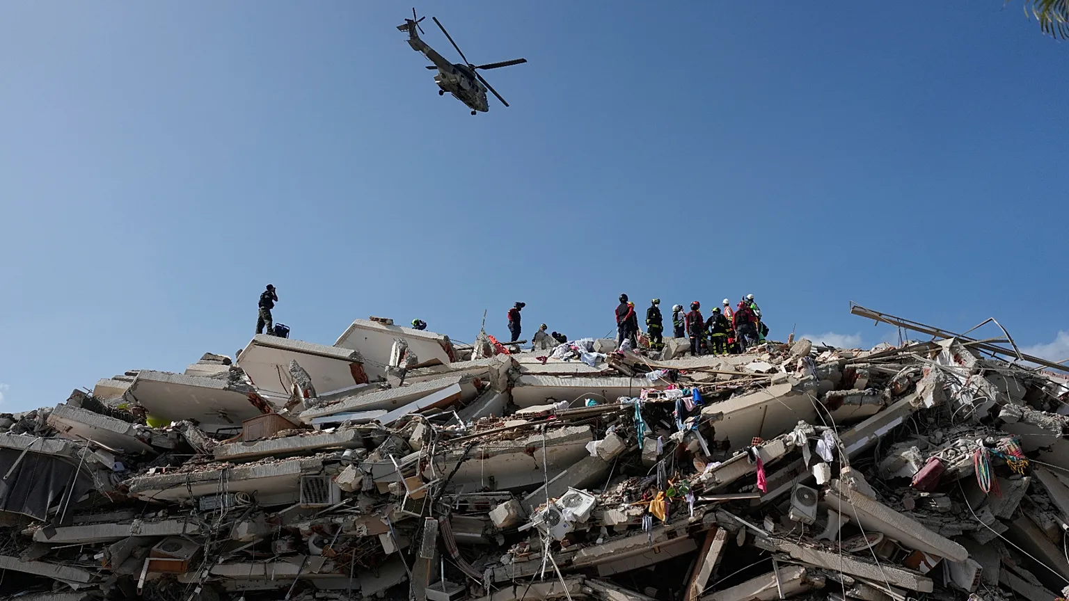 Rescue workers search through the rubble three days after earthquakes struck Catia La Mar, Venezuela, Saturday, June 27, 2026. (AP Photo/Fernando Vergara)
