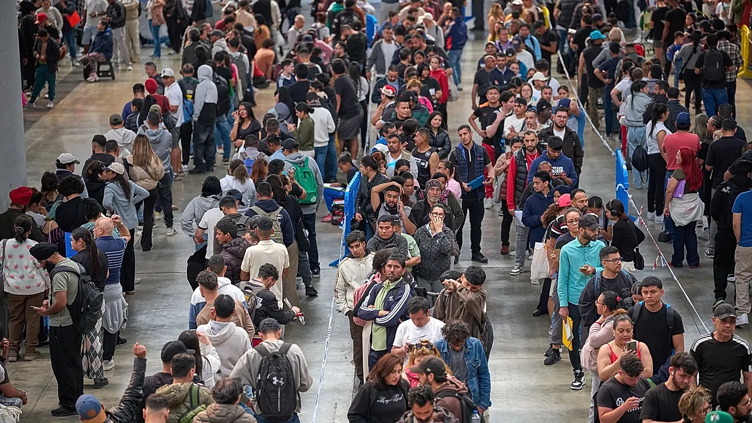 Migrants queue at a public service office to obtain paperwork needed to apply for Spain's immigration amnesty near Barcelona, 21 April, 2026