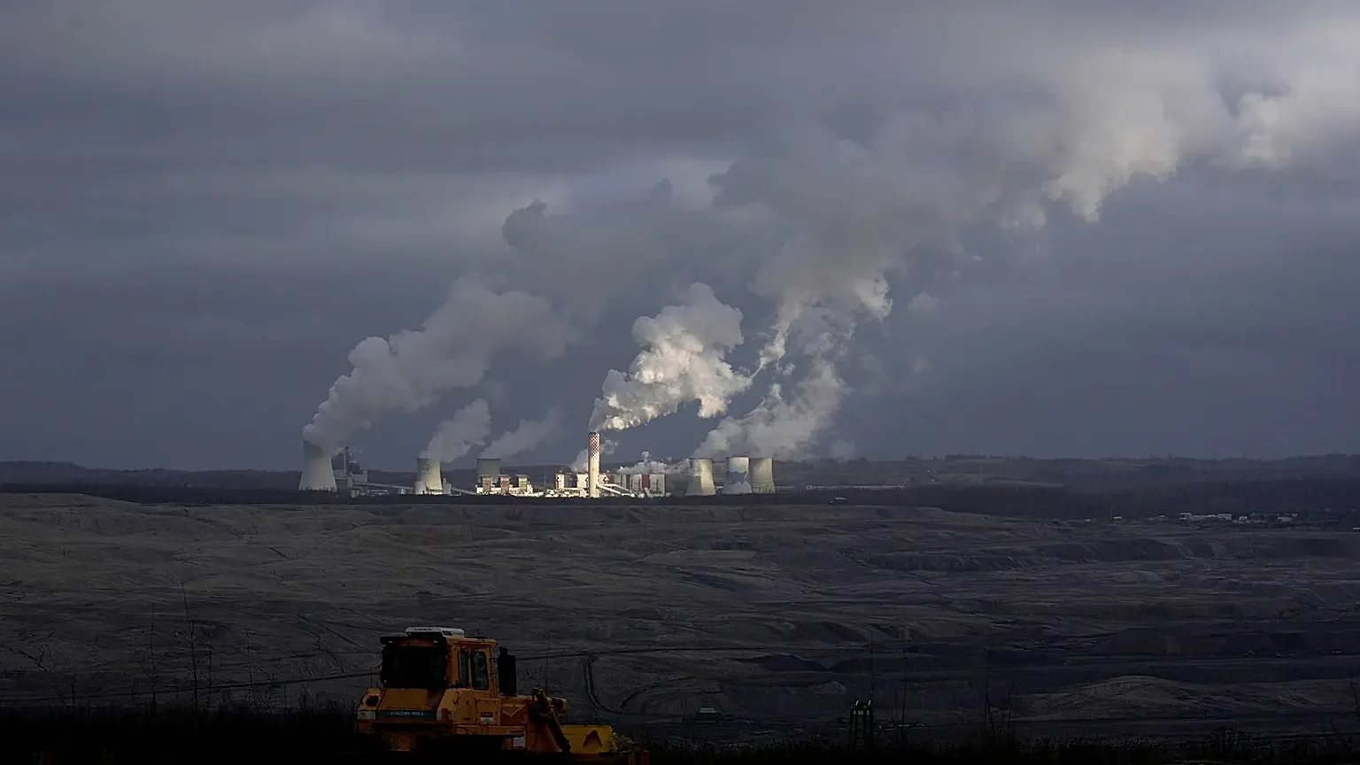 Steam and smoke rise from power plant located by the Turow lignite coal mine near the town of Bogatynia, Poland.