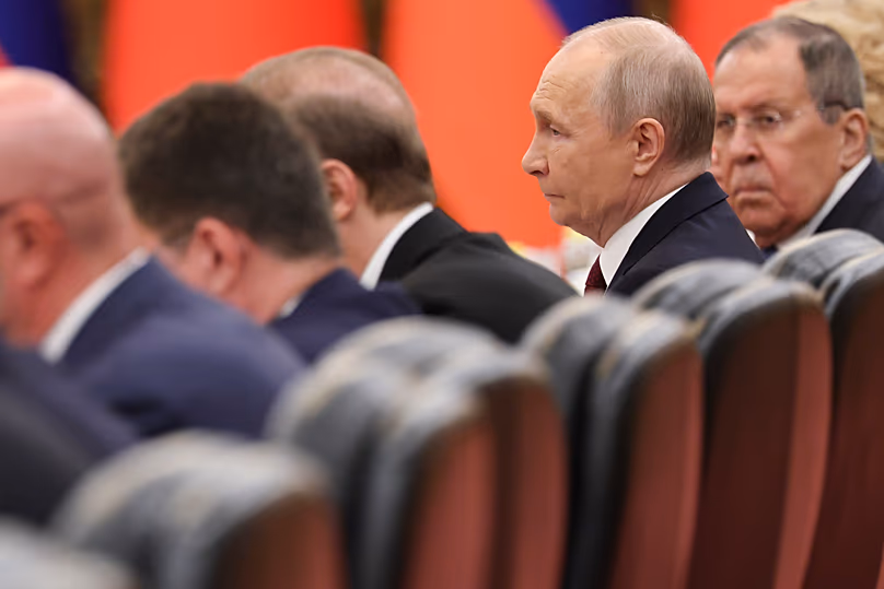 Russian President Vladimir Putin, second right, alongside Foreign Minister Sergei Lavrov, in Beijing 20 May, 2026.