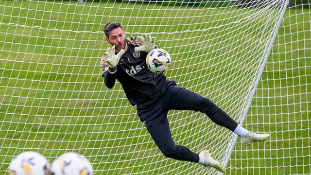Craig Gordon realiza una parada mientras entrena con su club, el Heart of Midlothian escocés, en Edimburgo el 7 de mayo. Viste de negro y salta con los brazos extendidos para detener el disparo.
