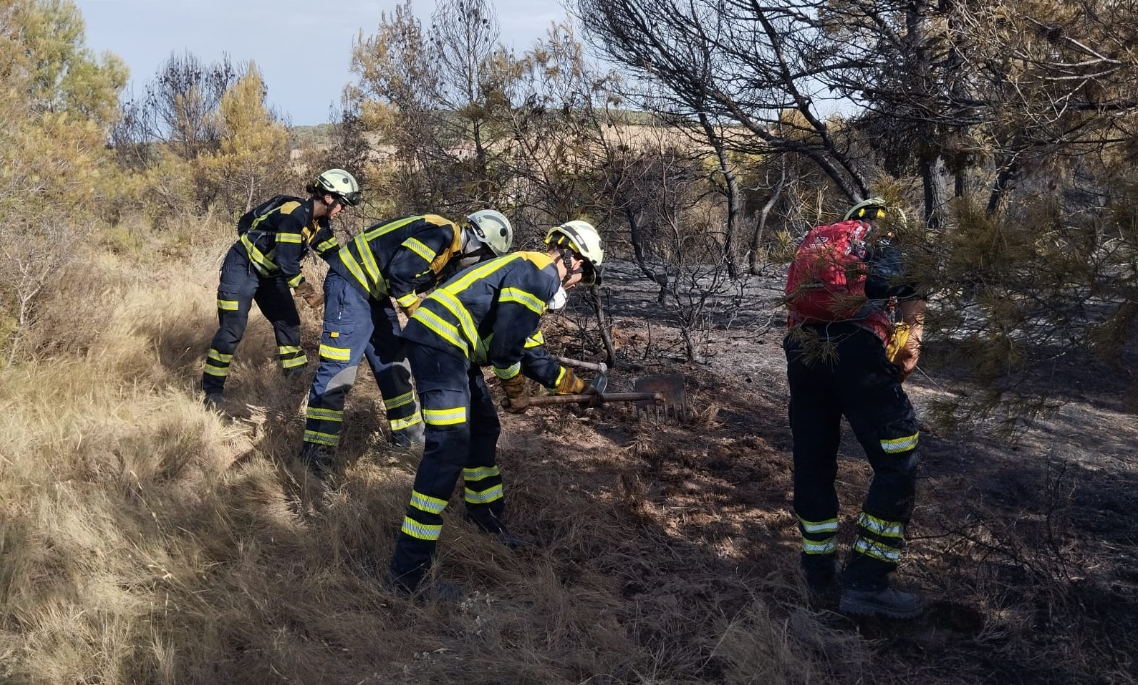 Equipo de bomberos trabajando en el interior del perímetro incendiado