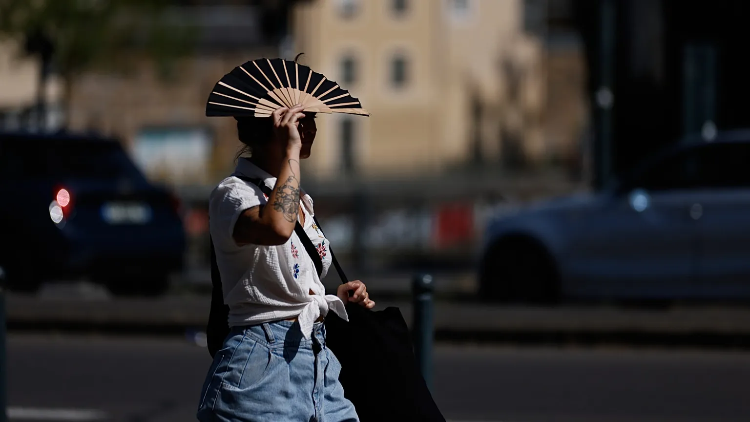 A woman shields herself from the sun in Rennes, France, on 22 June 2026.