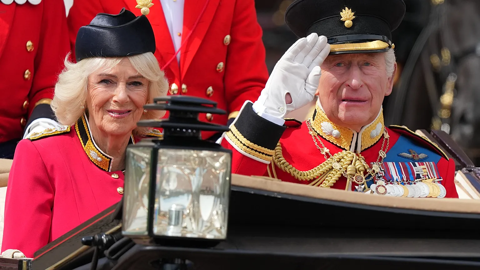 Britain's King Charles III, and Queen Camilla ride in an open top carriage during Trooping The Colour, the King's annual birthday parade, in London, Saturday, June 13, 2026. 