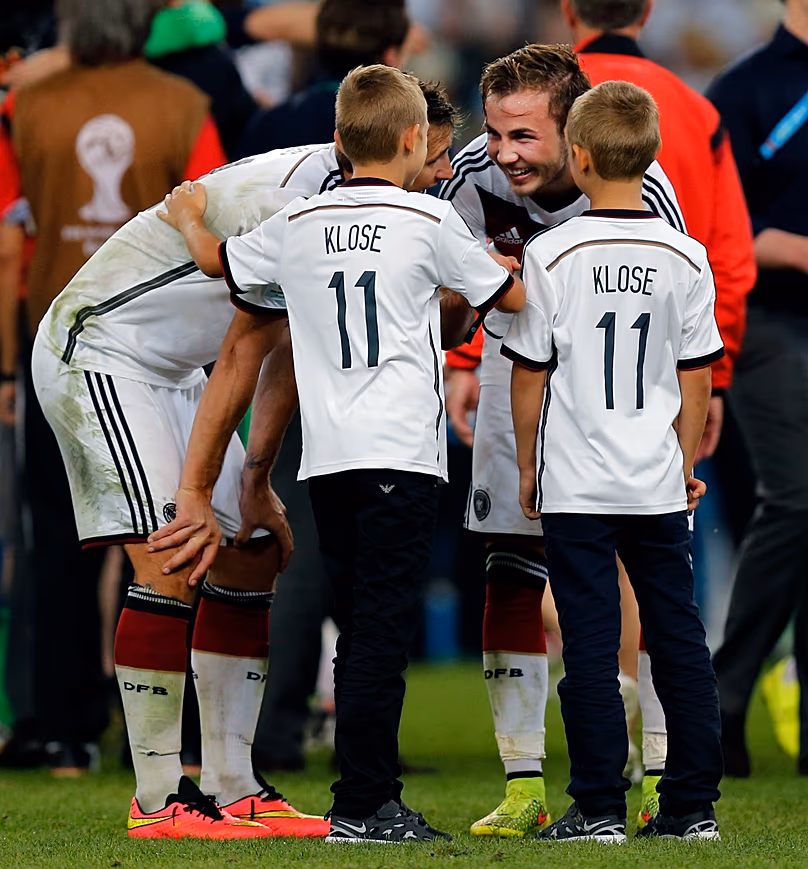 Footballer Mario Götze talks to the children of his team-mate Miroslav Klose after the World Cup final between Germany and Argentina in July 2014.
