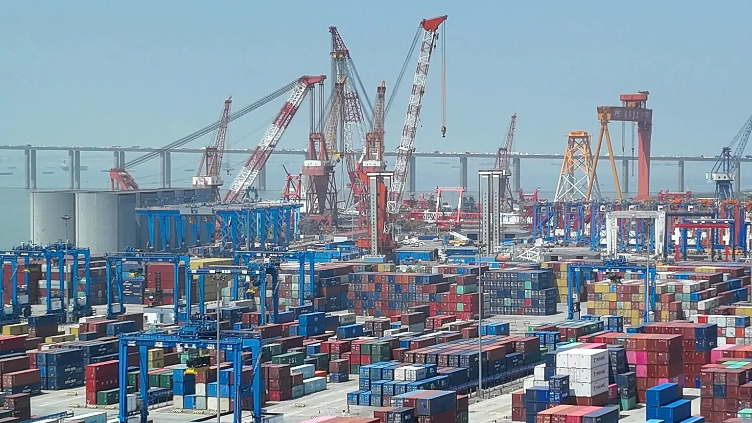Shipping containers are stacked on a dock at a port in Nantong in eastern China's Jiangsu Province, Monday, May 1, 2023.