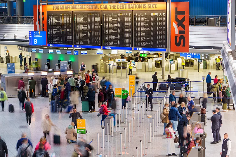 Passengers walk through Terminal 1 at Frankfurt Airport, 11 March, 2025 