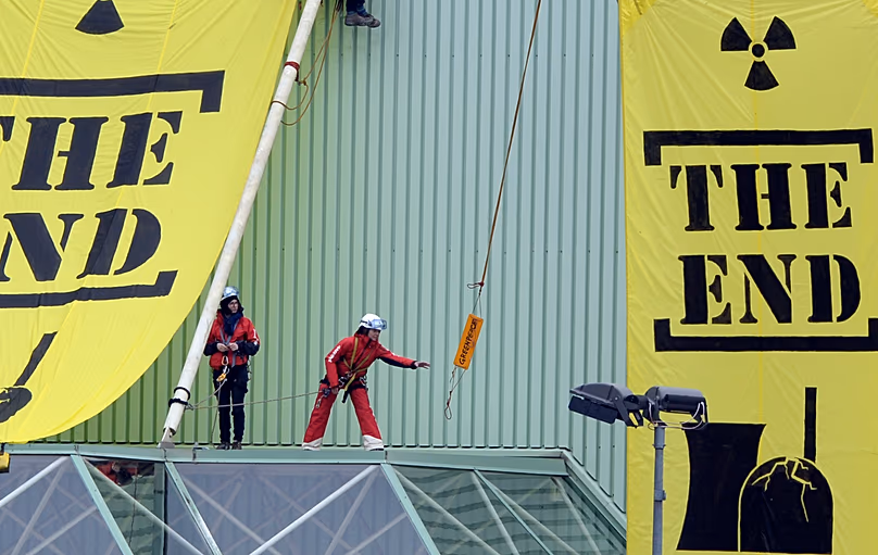 Greenpeace activists hang banners saying "The End" at a building of the Beznau nuclear power plant, 5 March, 2014 