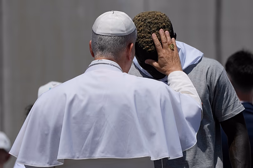 Pope Leo XIV blesses a migrant during a meeting with organisations working with migrants in Arguineguin at the Canary Islands, Spain, Thursday, June 11, 2026.
