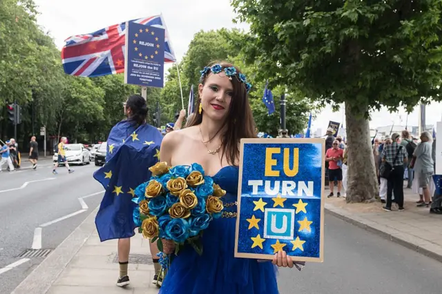 Una joven vestida con los colores de la bandera de la Unión Europea.