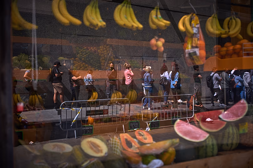 Migrants queue outside Barcelona City Hall to obtain paperwork needed to apply for Spain's immigration amnesty, 20 April, 2026