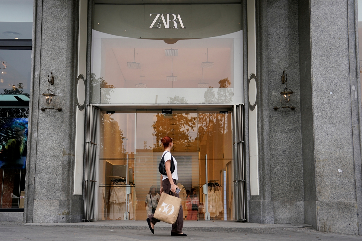 Una persona que lleva una bolsa pasa junto a una tienda Zara. (REUTERS/Ana Beltran)
