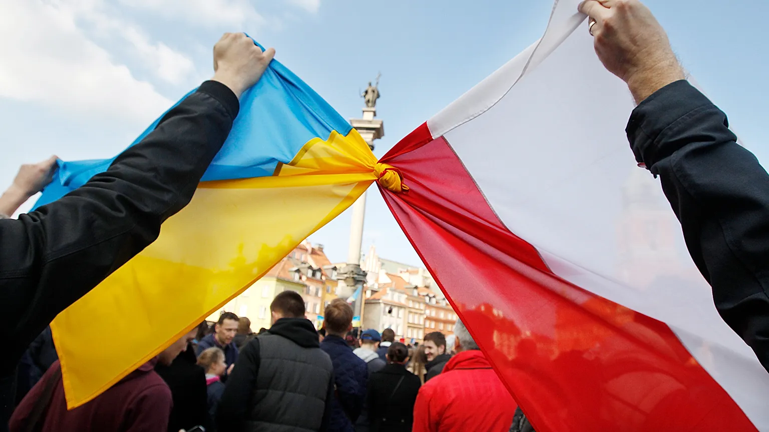FILE: People hold tied Polish and Ukrainian flags during a demonstration in Warsaw, Poland, Sunday, Feb. 23, 2014