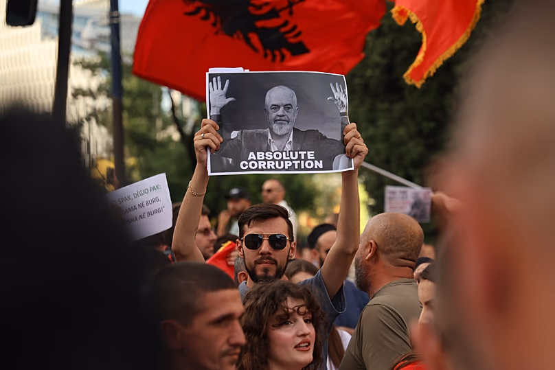Protesters with a poster depicting Prime Minister Edi Rama take part in a rally in Tirana, 6 June, 2026 