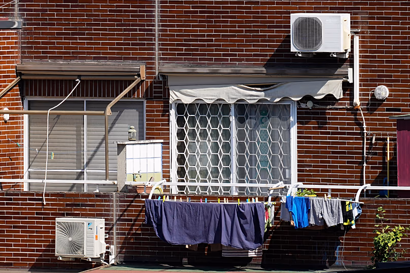Air conditioning external units are seen on the facade of a building in Rome, Tuesday, July 25, 2023. 