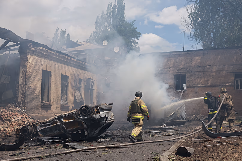 Rescue workers put out a fire at a building destroyed after a Russian strike on Zaporizhzhia, 26 June, 2026