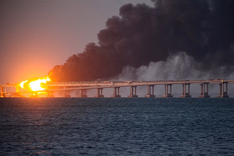 FILE - Flame and smoke rise from Crimean Bridge connecting Russian mainland and Crimean peninsula over the Kerch Strait, in Kerch, Crimea, on Oct. 8, 2022.