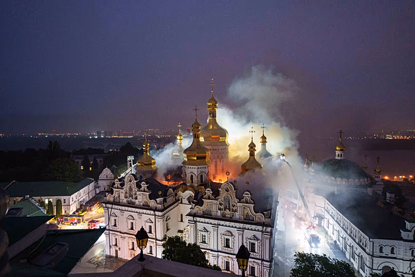 Rescue workers try to put out a fire at the Dormition Cathedral of thousand-year-old Monastery of Caves, also known as Kyiv Pechersk Lavra, following a Russian strike on Kyiv,