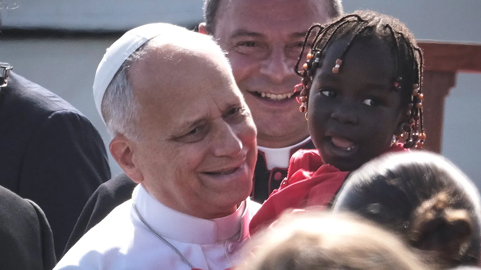 Pope Leo XIV holds a child on his arrival at a meeting with migrants in San Cristóbal de La Laguna, Tenerife, Spain, Friday 12 June 2026.