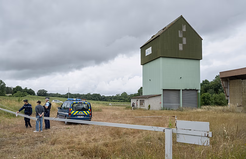 French police guard a farm silo where a body was found during the search to find missing 11 year-old girl Lyhanna in Puycasquier, southwestern France, 5 June 2026.