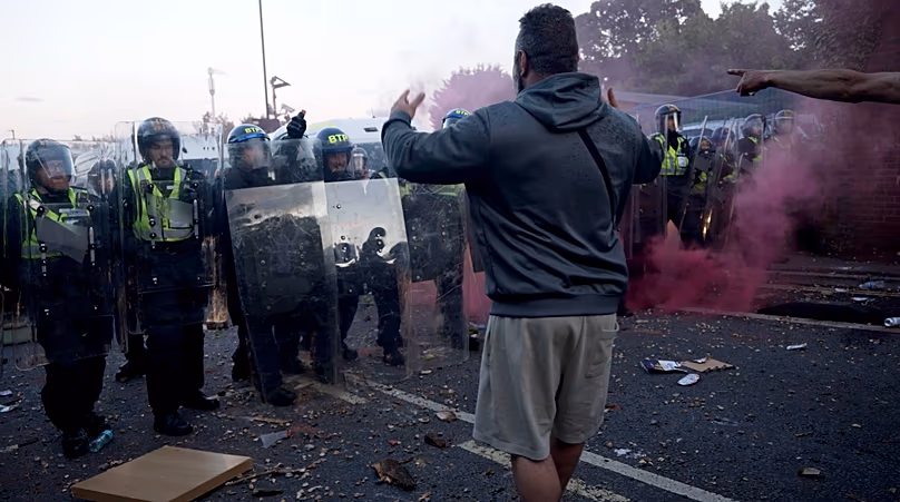 In this image taken from PA Video, police and protestors clash during a protest following the death of Henry Nowak, a 18-year-old student stabbed to death.