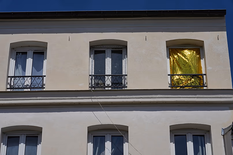A thermal blanket covers a window to help keep out the heat during a heatwave in Saint-Germain-en-Laye, west of Paris, Thursday, June 25, 2026. 
