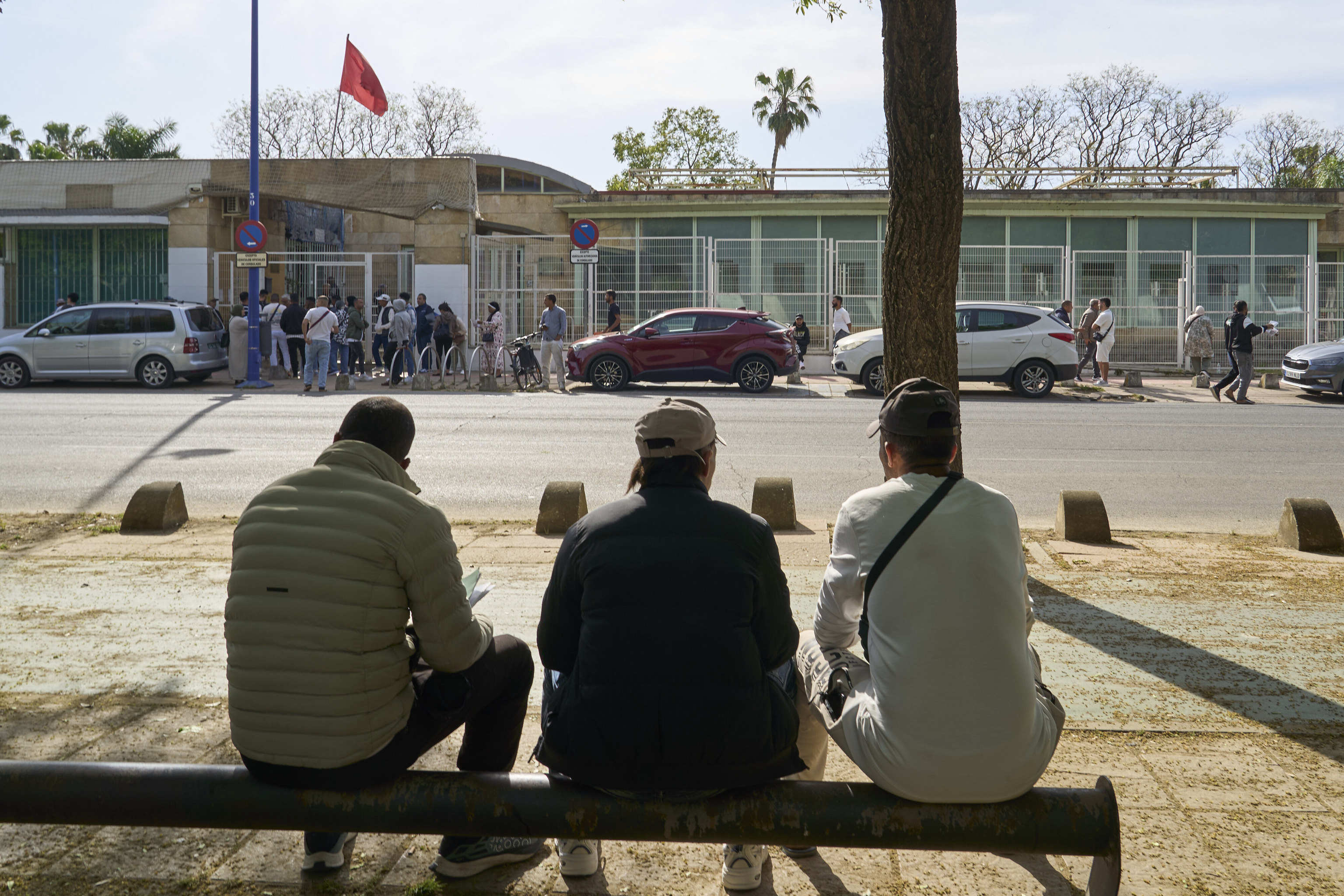 Varias personas extranjeras hacen cola para conseguir documentacion en el consulado de Marruecos en Sevilla.