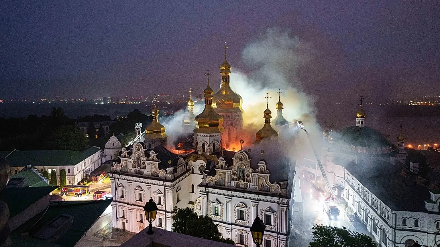 Rescue workers try to put out a fire at the Dormition Cathedral in Kyiv, 15 June, 2026