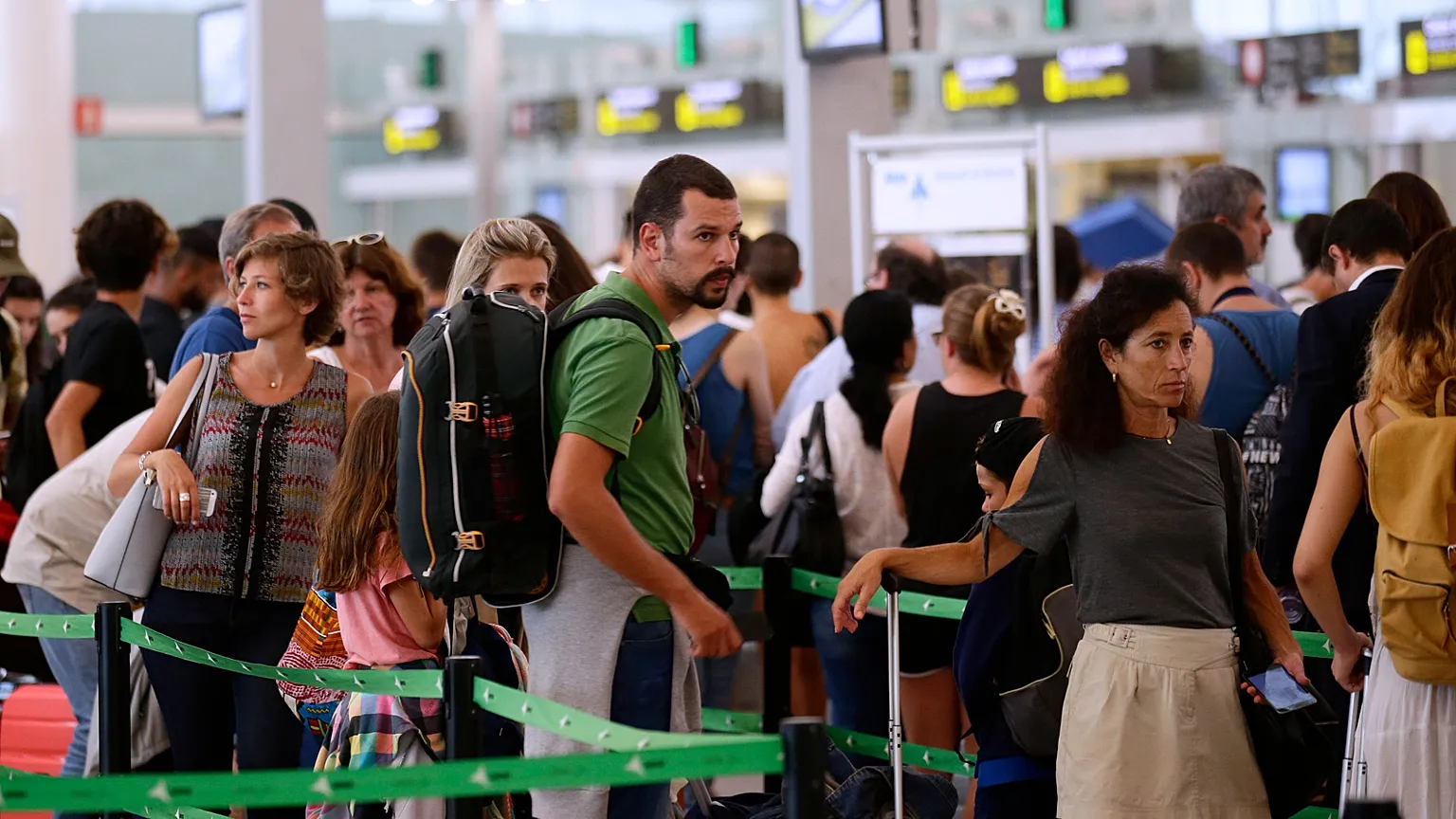 Passenger wait for pass the security control at the Barcelona airport in Prat Llobregat, Spain, Tuesday, Aug. 1, 2017. Passenger are facing hours of extra-long security queues